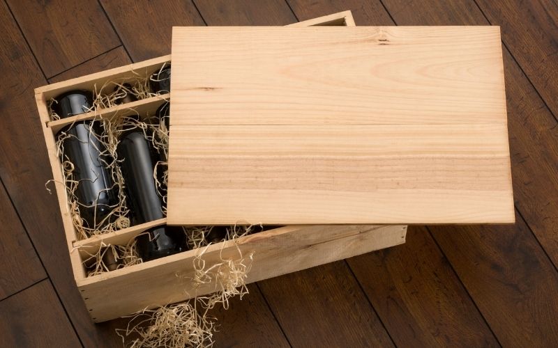 Photo of several bottles of wine in a wooden crate