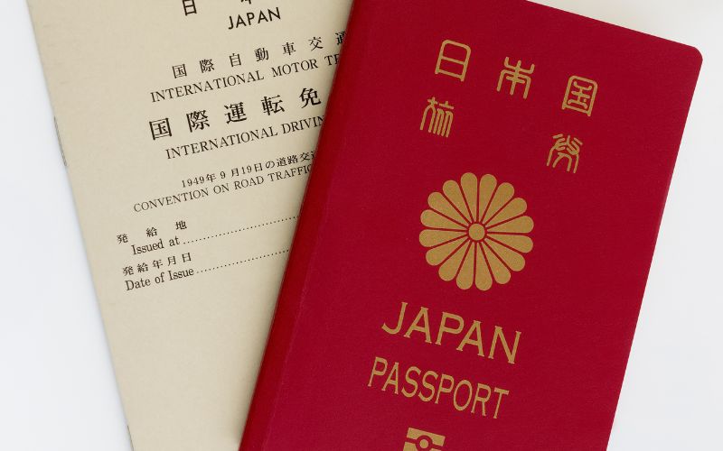 Photo showing a red passport and International driver permit from Japan