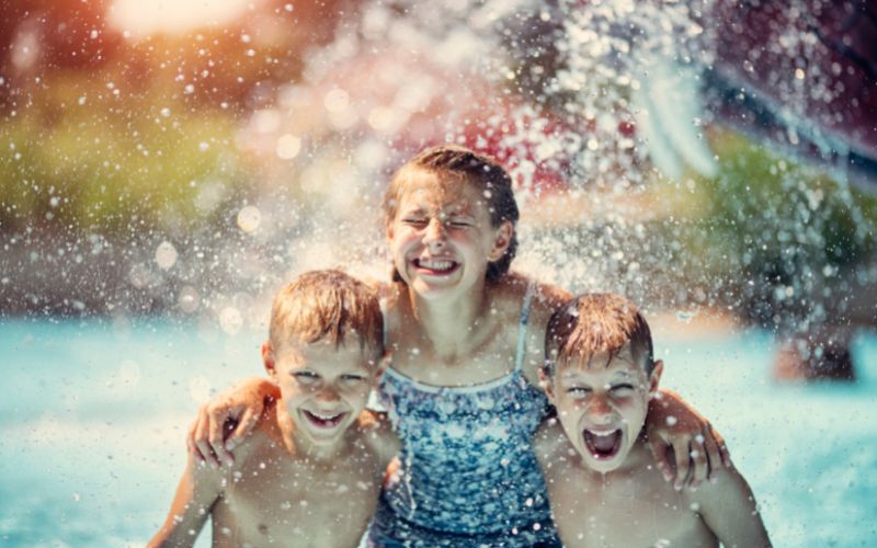Three kids having fun in a waterpark_Things to Do in Malaga With Kids_Aquamijas Waterpark