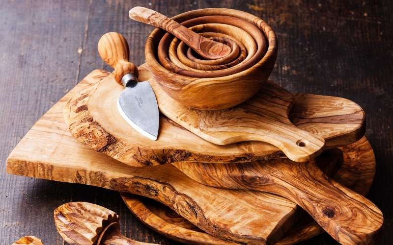 olive wood tableware on dark wooden background