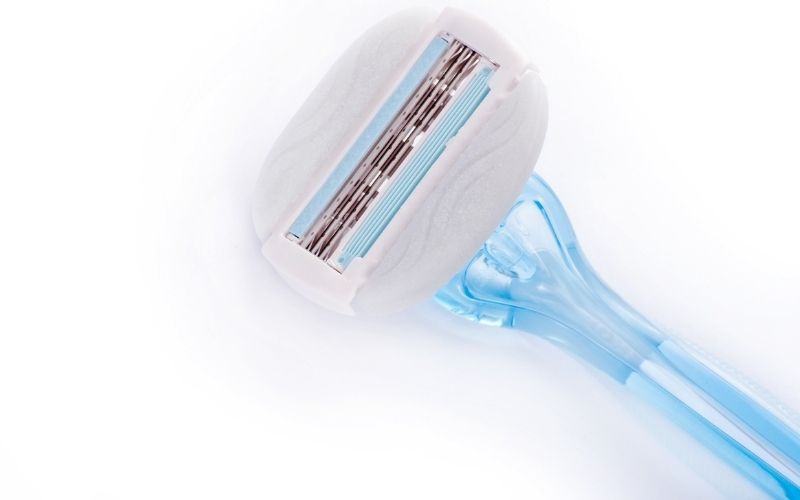 Photo of a blue razor in white background