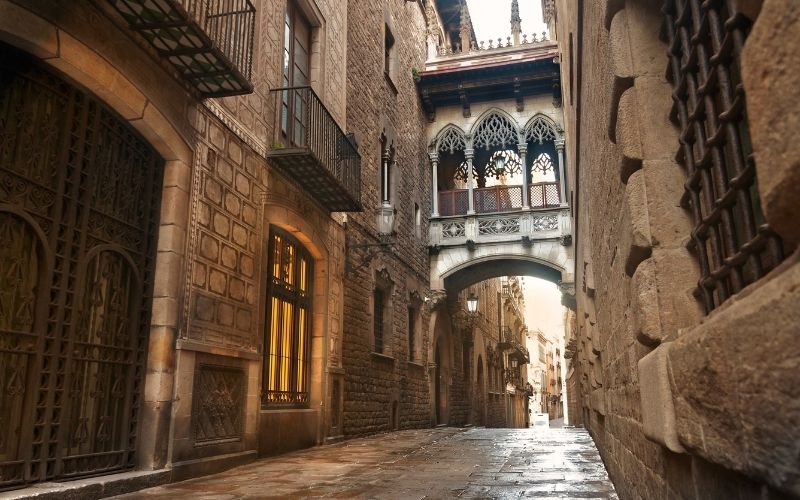 Photo showing a old looking narrow street with building on both sides