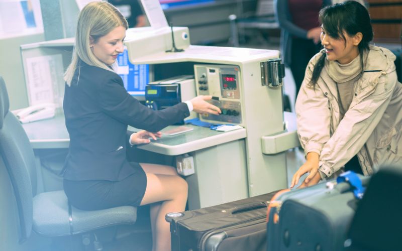 Photo of a woman looking at the luggages of another woman