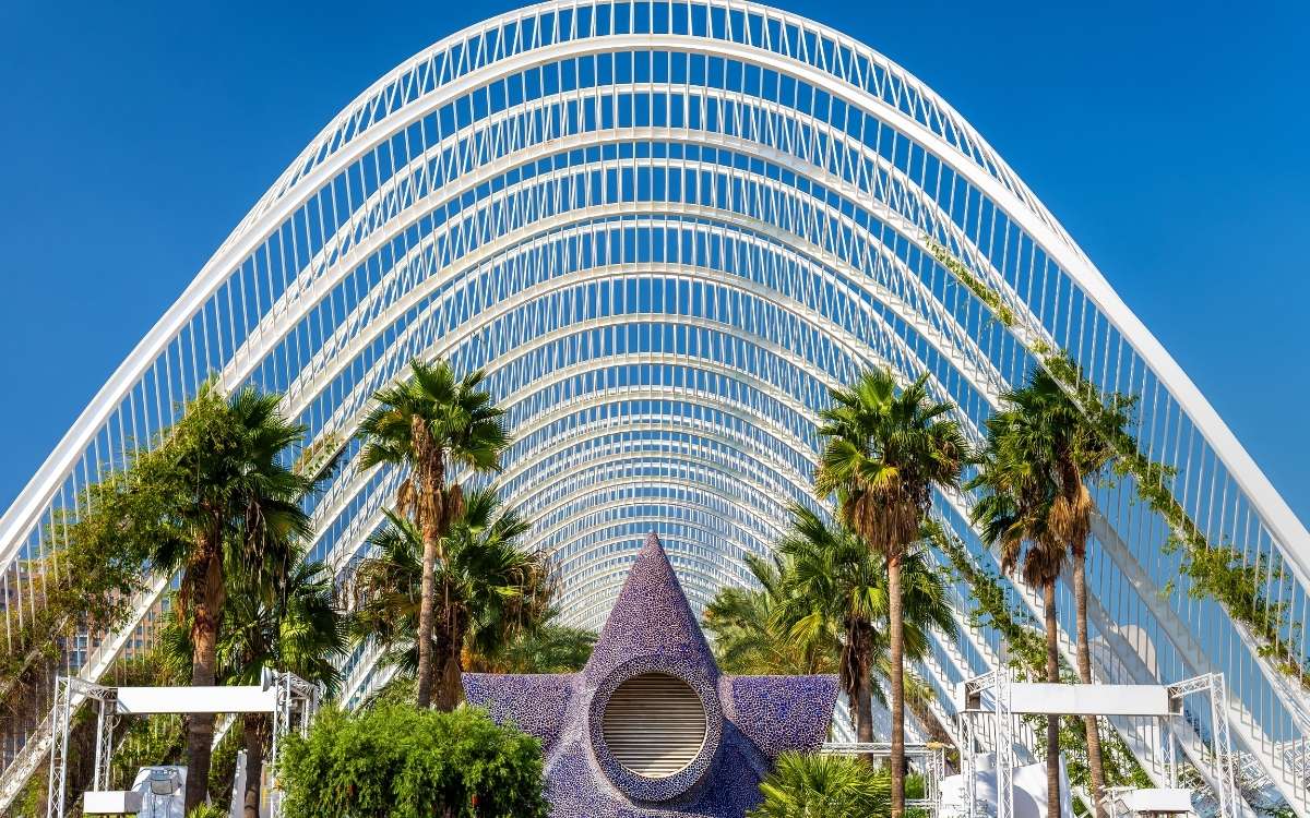 Photo showing several white arc-like structures with palm trees and large star-shaped display